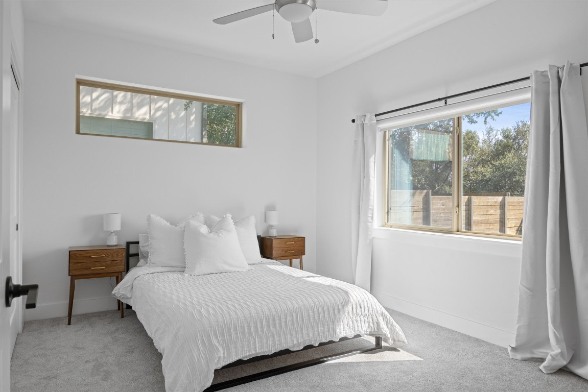 5315 La Crosse Avenue, Unit 18 Austin, TX 78739 - Photo 6 of 40 Bedroom featuring light carpet and a ceiling fan