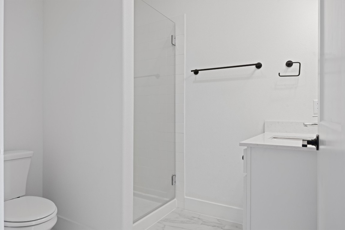 5315 La Crosse Avenue, Unit 18 Austin, TX 78739 - Photo 7 of 40 Full bath featuring a stall shower, vanity, and light marble finish floors