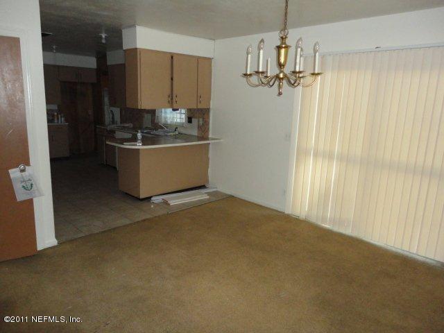 5706 Silver Street Jacksonville, FL 32208 - Photo 5 of 8 a room with a window and a chandelier