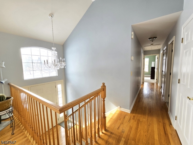 63 Halsey Road Newton, NJ 07860 - Photo 9 of 35 a view of a hallway with wooden floor and chandelier