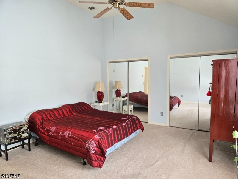 63 Halsey Road Newton, NJ 07860 - Photo 10 of 35 a bedroom with a bed and a chandelier