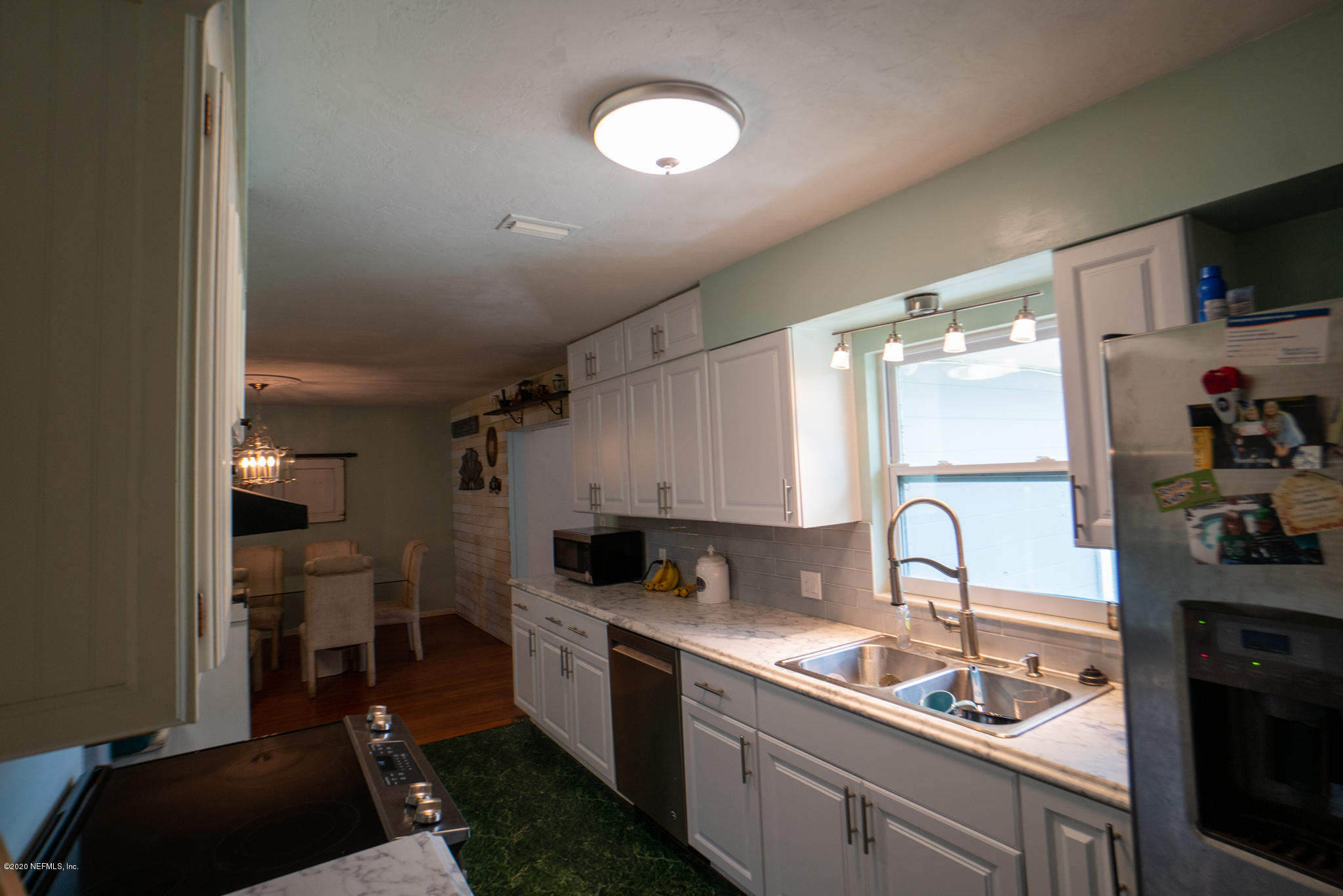 655 Pointview Road Keystone Heights, FL 32656 - Photo 12 of 38 a kitchen with stainless steel appliances a sink stove and cabinets