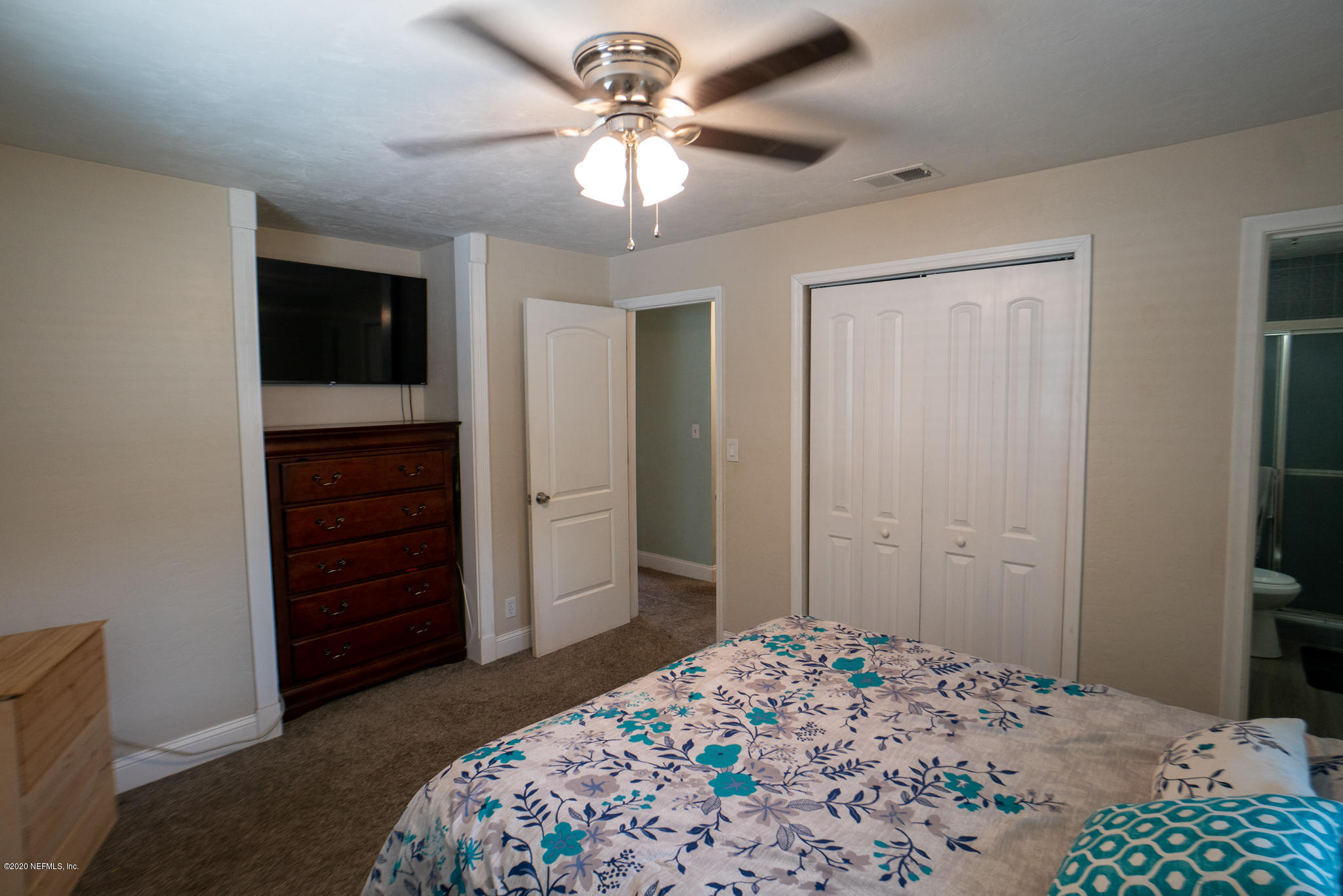 655 Pointview Road Keystone Heights, FL 32656 - Photo 14 of 38 a bedroom with a bed and a chandelier