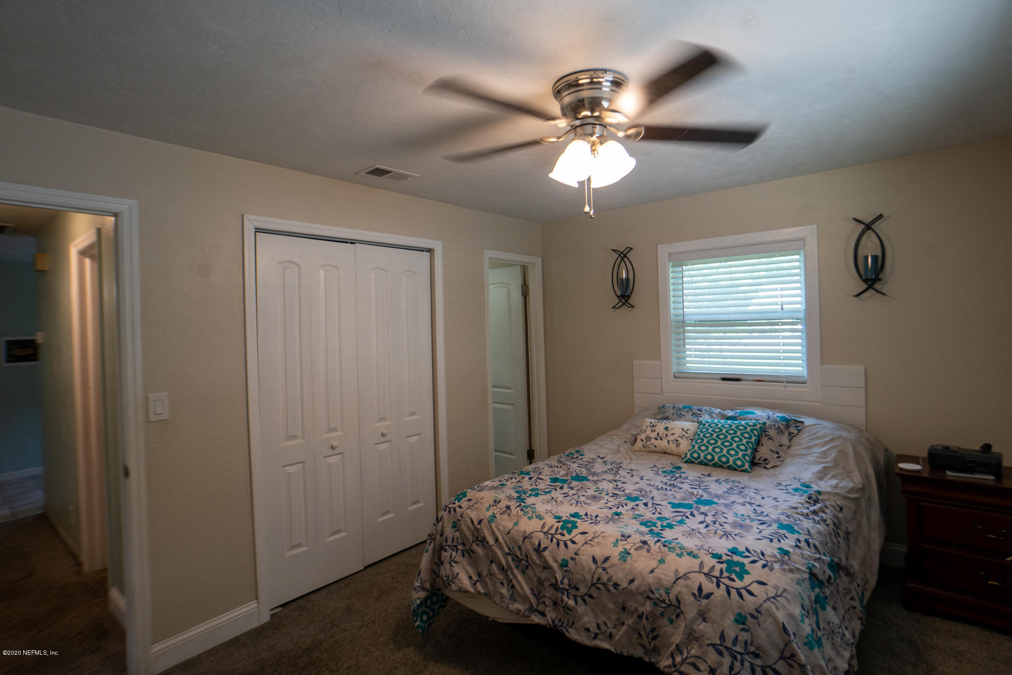 655 Pointview Road Keystone Heights, FL 32656 - Photo 15 of 38 a bedroom with a bed and a chandelier