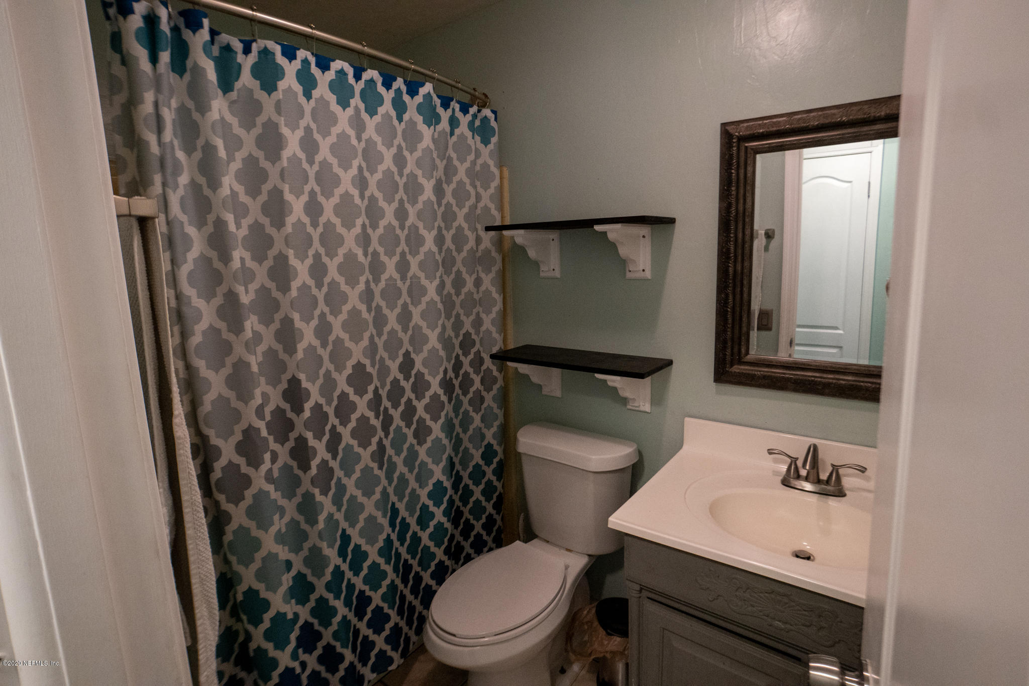 655 Pointview Road Keystone Heights, FL 32656 - Photo 20 of 38 a white toilet sitting next to a bathroom sink