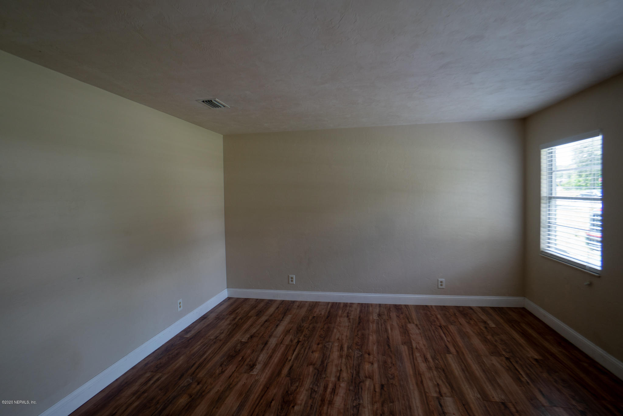 655 Pointview Road Keystone Heights, FL 32656 - Photo 24 of 38 a view of an empty room and wooden floor and window