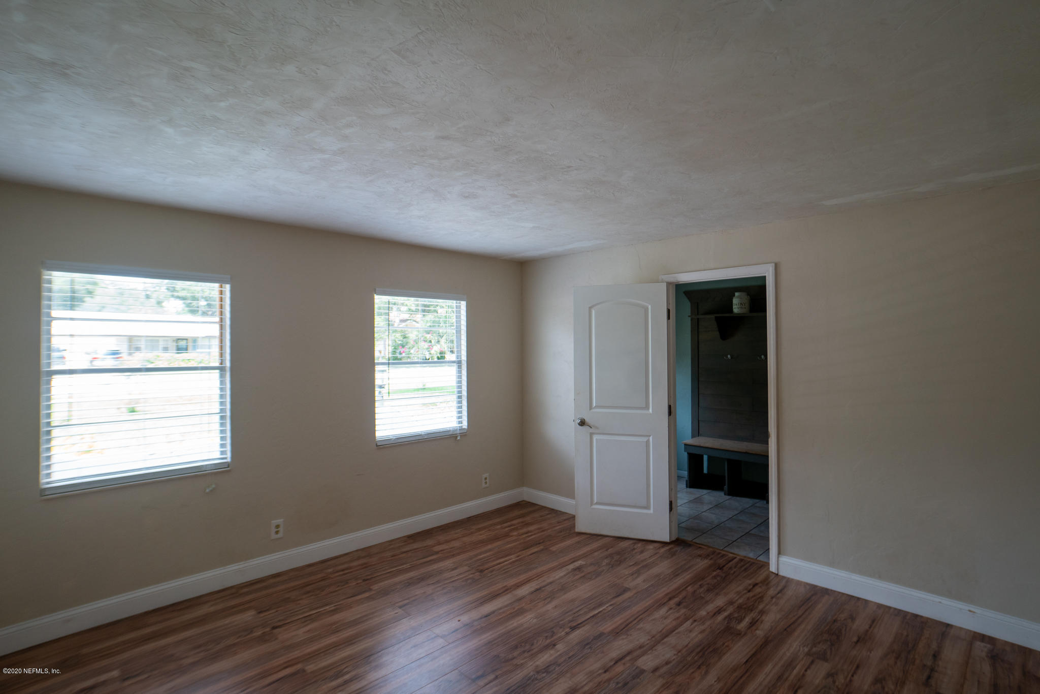 655 Pointview Road Keystone Heights, FL 32656 - Photo 26 of 38 an empty room with wooden floor and windows