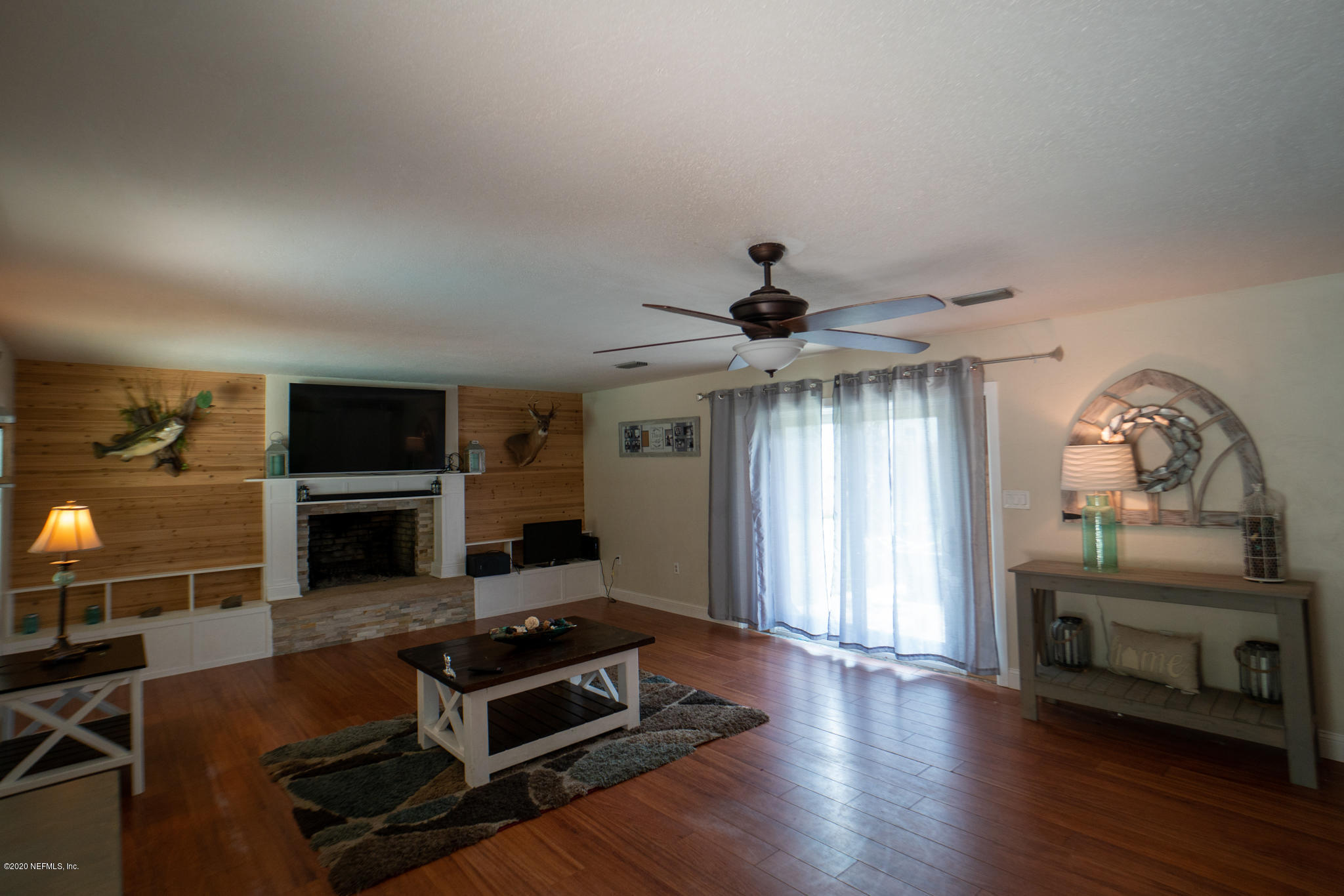 655 Pointview Road Keystone Heights, FL 32656 - Photo 4 of 38 a living room with furniture a flat screen tv and a fireplace