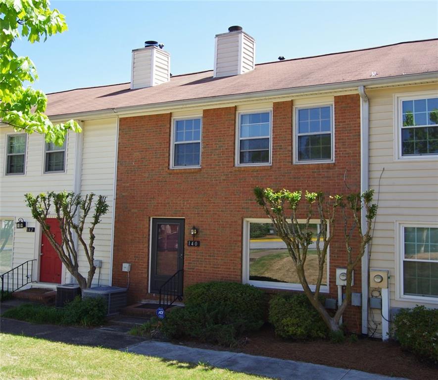140 Holcomb Ferry Road Roswell, GA 30076 - Photo 1 of 1 a front view of a house with a yard