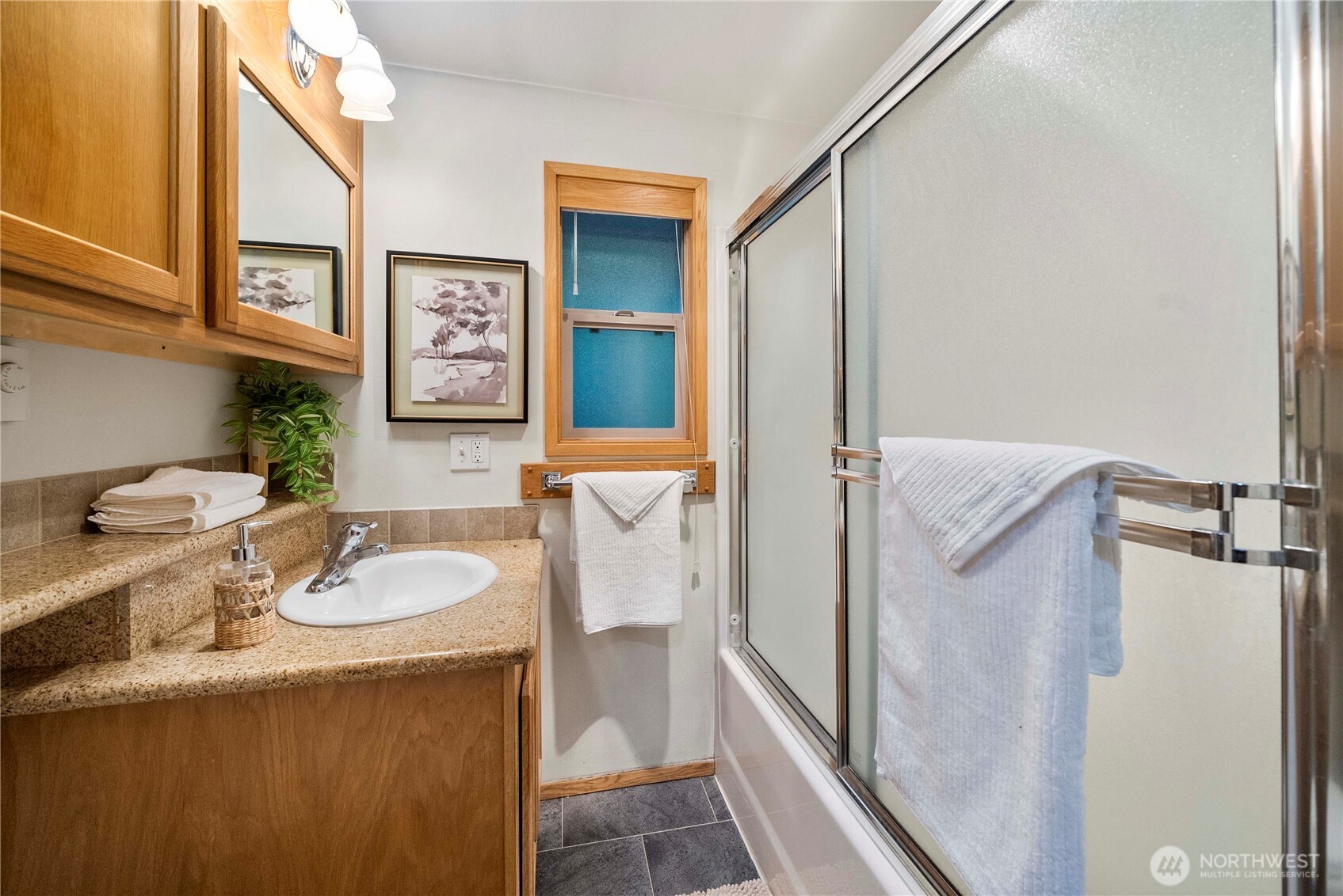 1546 Reservation Road Southeast, Unit 62 Olympia, WA 98513 - Photo 10 of 39 a bathroom with a granite countertop sink and a mirror