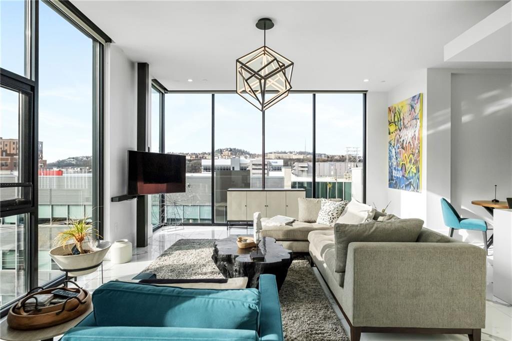 2554 Smallman Street, Unit 501 Pittsburgh, PA 15222 - Photo 12 of 45 a living room with furniture and a floor to ceiling window