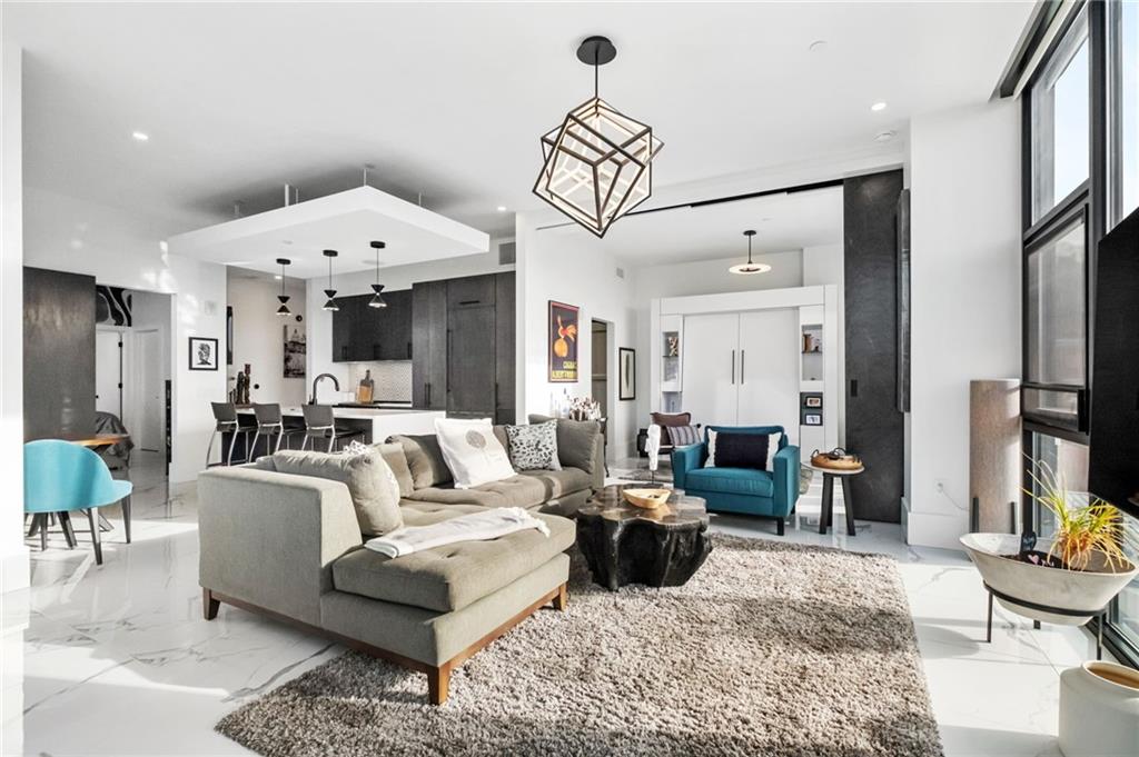 2554 Smallman Street, Unit 501 Pittsburgh, PA 15222 - Photo 14 of 45 a living room with furniture or couch and a chandelier