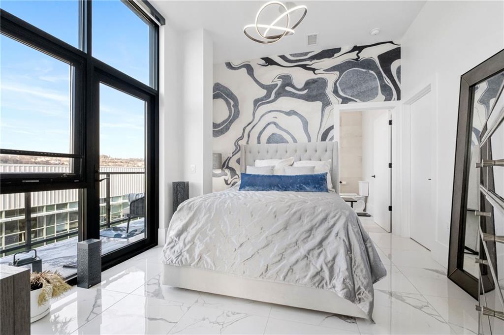 2554 Smallman Street, Unit 501 Pittsburgh, PA 15222 - Photo 22 of 45 a bedroom with a large bed and a window