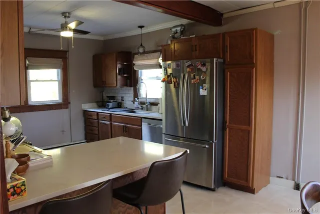 a kitchen with a refrigerator a sink and cabinets