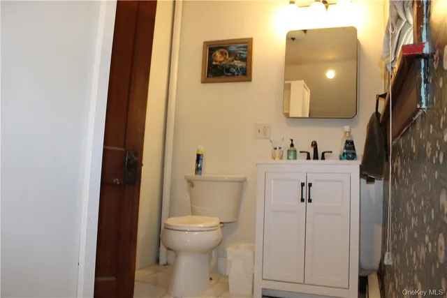a bathroom with a toilet sink and vanity