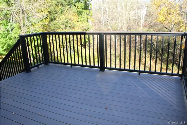 a view of a balcony with wooden floor