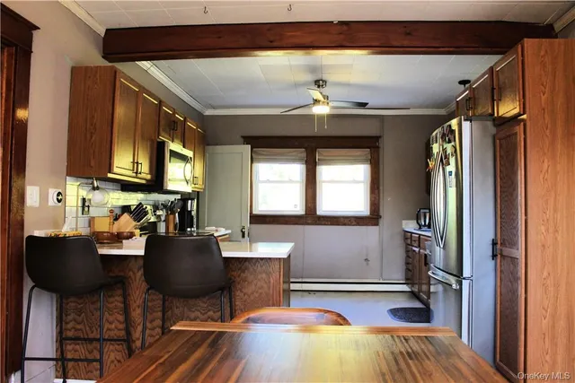 a view of a dining room with furniture and chandelier