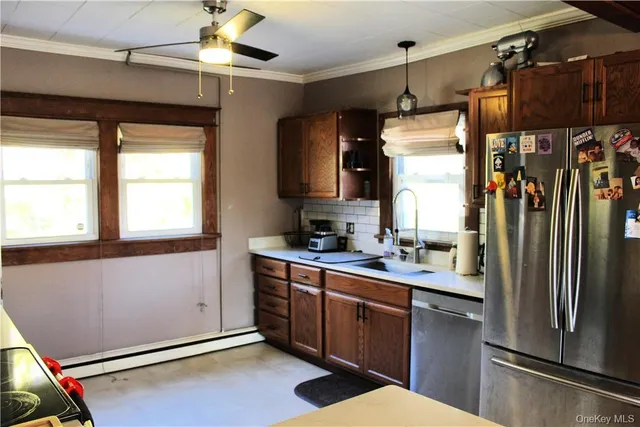 a kitchen with stainless steel appliances granite countertop a refrigerator and a sink