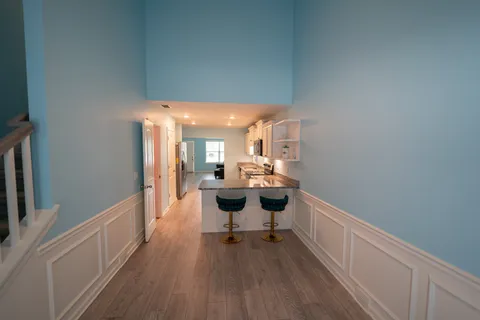 a living room with furniture and a wooden floor