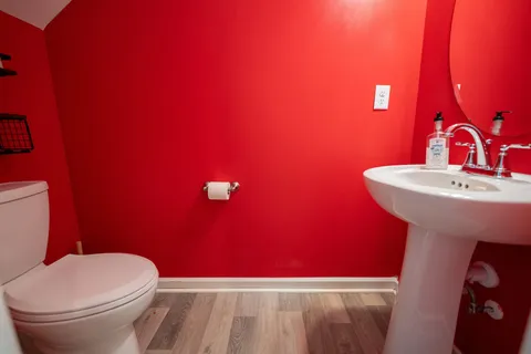 a bathroom with a sink mirror and toilet