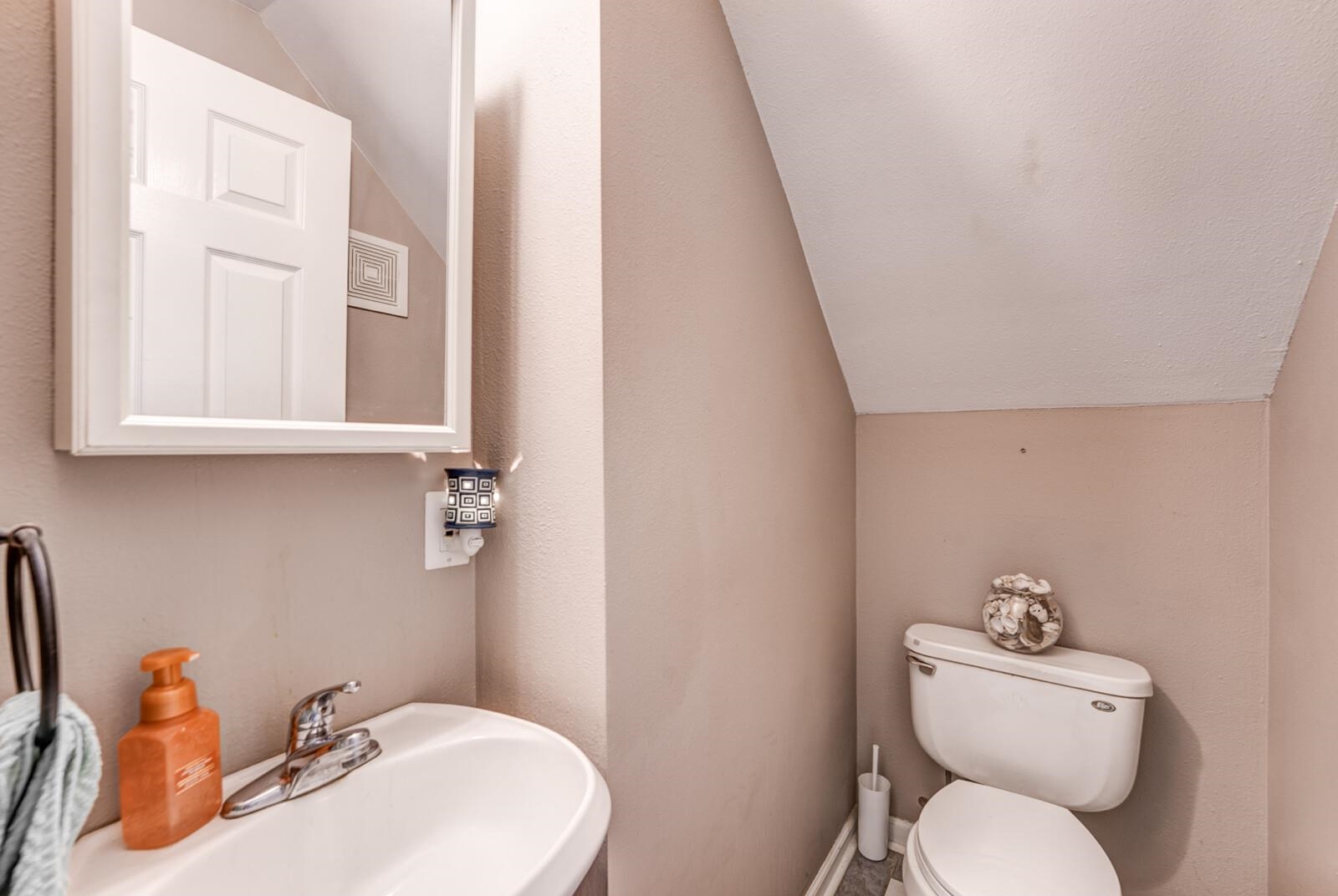 10 Raphael Cove Munford, TN 38058 - Photo 9 of 23 a bathroom with a toilet sink and mirror