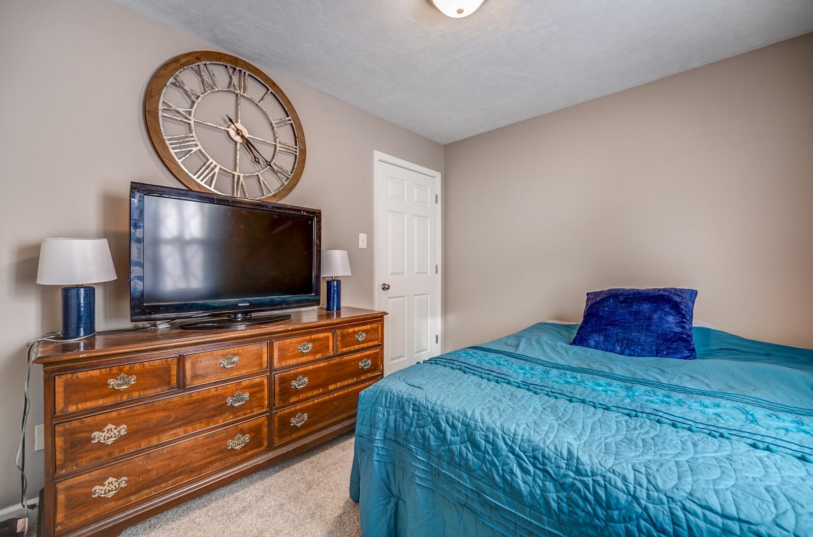 10 Raphael Cove Munford, TN 38058 - Photo 16 of 23 a bedroom with a bed and a flat screen tv