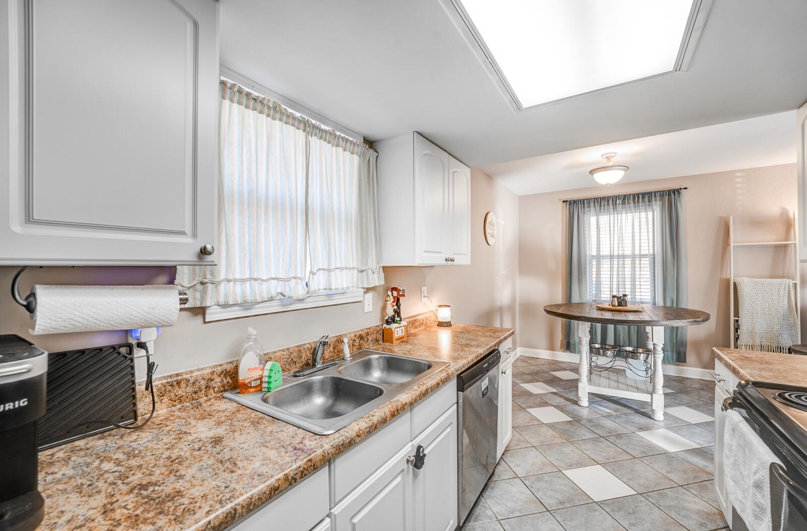 10 Raphael Cove Munford, TN 38058 - Photo 8 of 23 a kitchen with granite countertop a sink and a stove top oven
