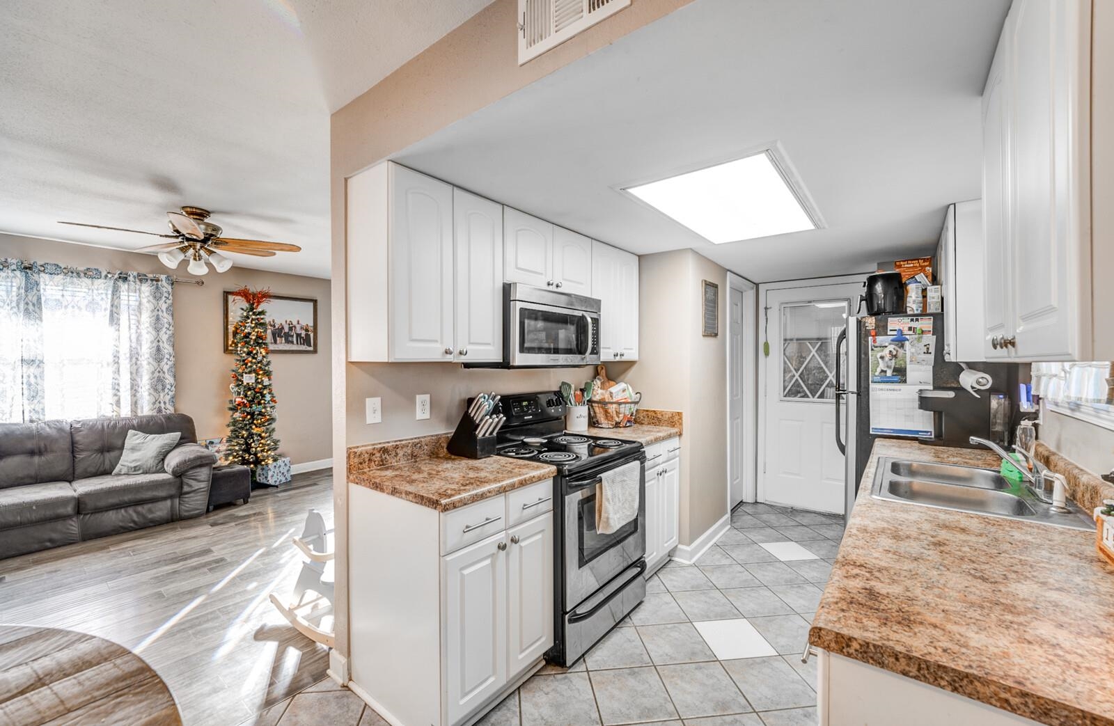 10 Raphael Cove Munford, TN 38058 - Photo 22 of 23 a kitchen with granite countertop a sink stove and refrigerator