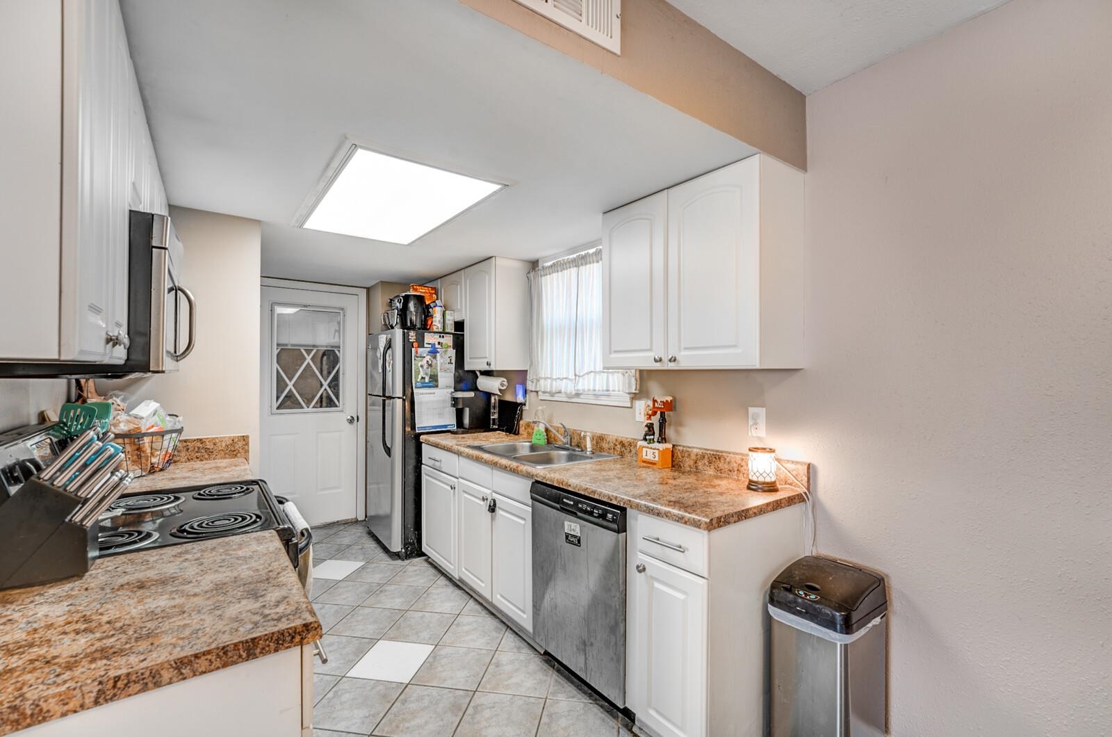 10 Raphael Cove Munford, TN 38058 - Photo 23 of 23 a kitchen with stainless steel appliances granite countertop a sink stove and refrigerator