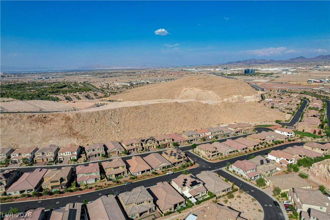 3943 Reyes Avenue Las Vegas, NV 89141 - Photo 74 of 95 An aerial perspective reveals a developing community nestled against desert mountains.
