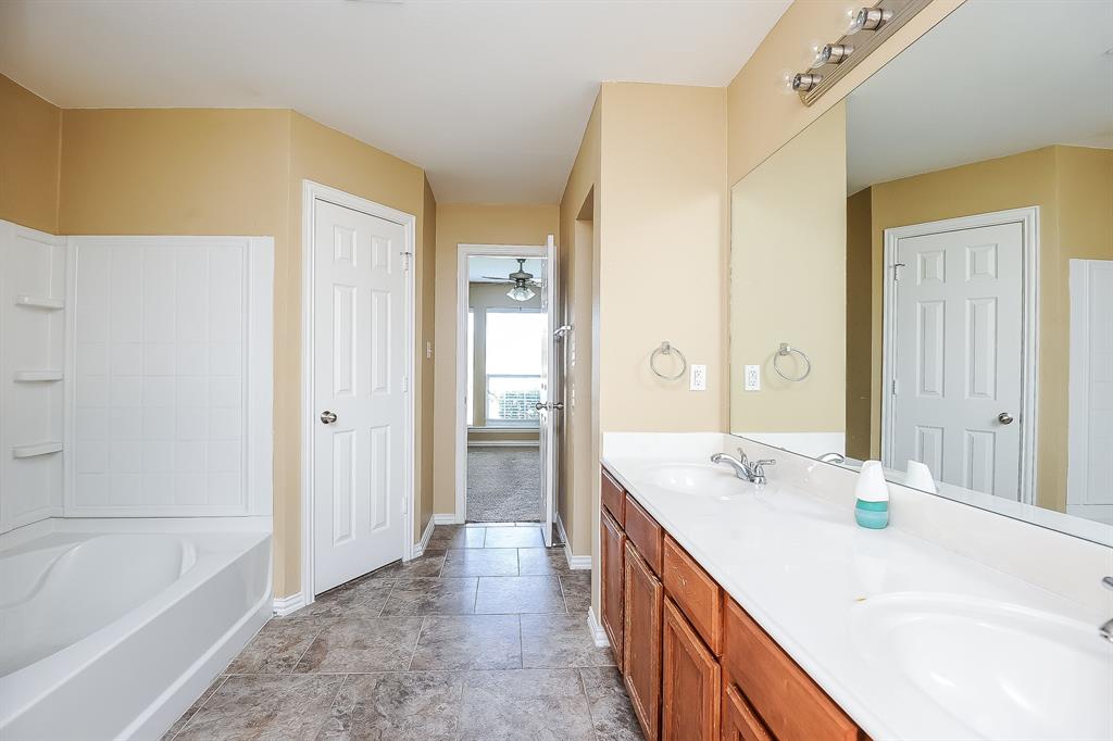 113 Currie Court Crowley, TX 76036 - Photo 11 of 16 a bathroom with a tub sink and mirror