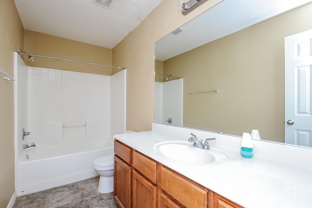 113 Currie Court Crowley, TX 76036 - Photo 14 of 16 a bathroom with a granite countertop sink and a bathtub