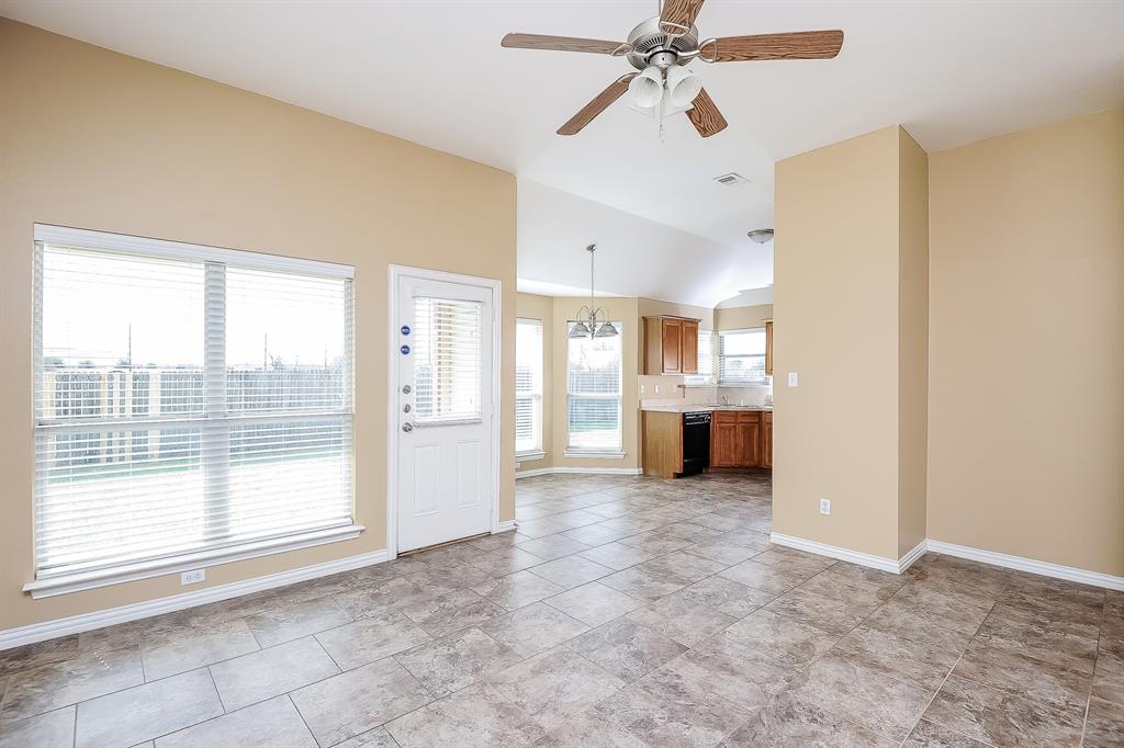 113 Currie Court Crowley, TX 76036 - Photo 3 of 16 a view of a big room with windows and chandelier fan
