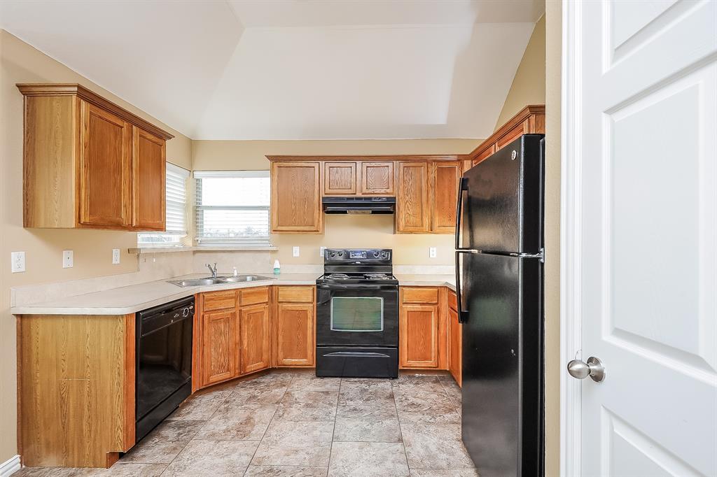 113 Currie Court Crowley, TX 76036 - Photo 6 of 16 a kitchen with stainless steel appliances granite countertop a refrigerator and a sink