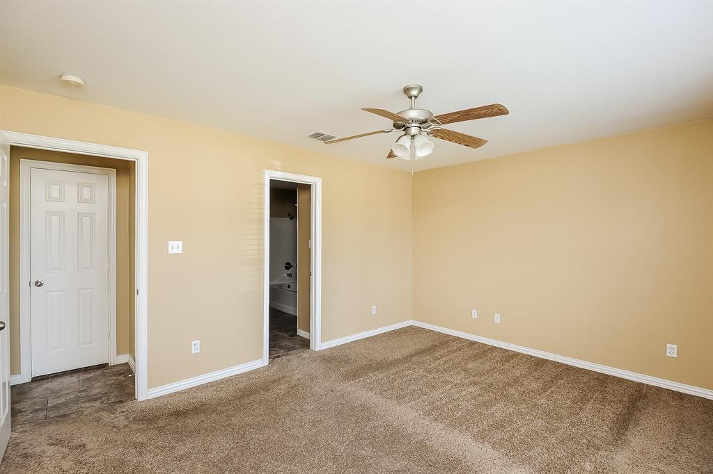 113 Currie Court Crowley, TX 76036 - Photo 9 of 16 an empty room with a ceiling fan and a window