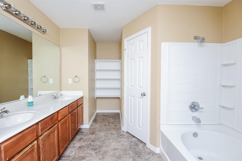 113 Currie Court Crowley, TX 76036 - Photo 10 of 16 a bathroom with a double vanity sink mirror and bathtub