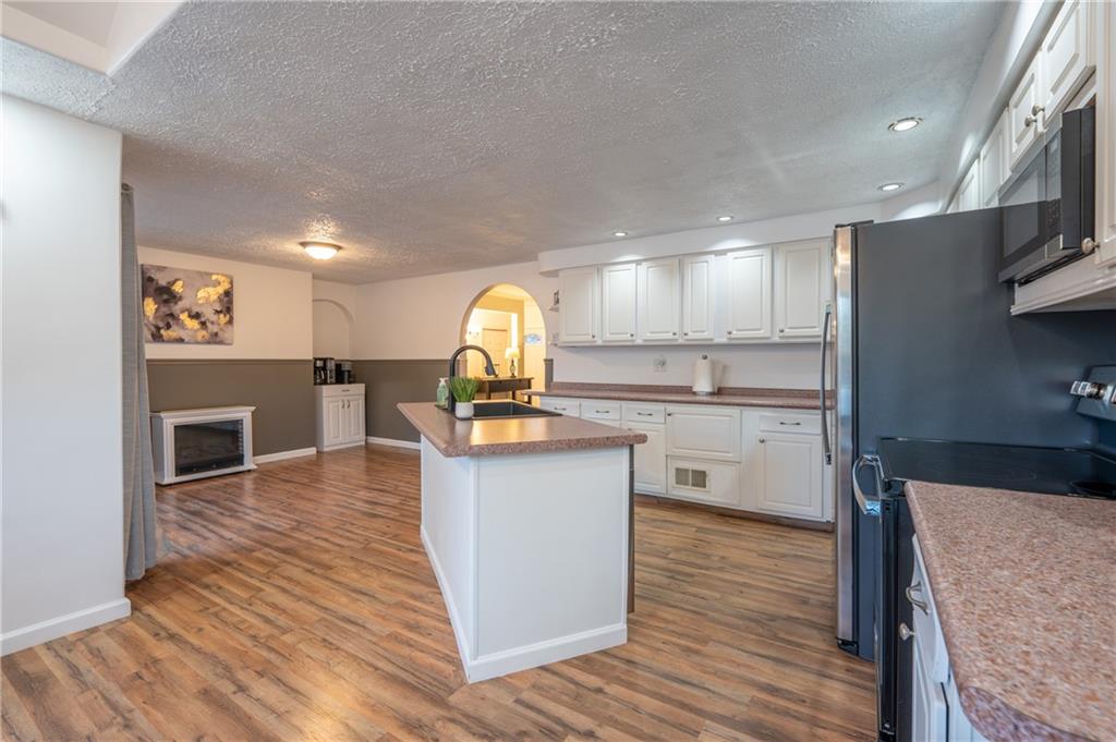 136 Long Drive Irwin, PA 15642 - Photo 11 of 50 a kitchen with stainless steel appliances granite countertop a sink counter space and cabinets