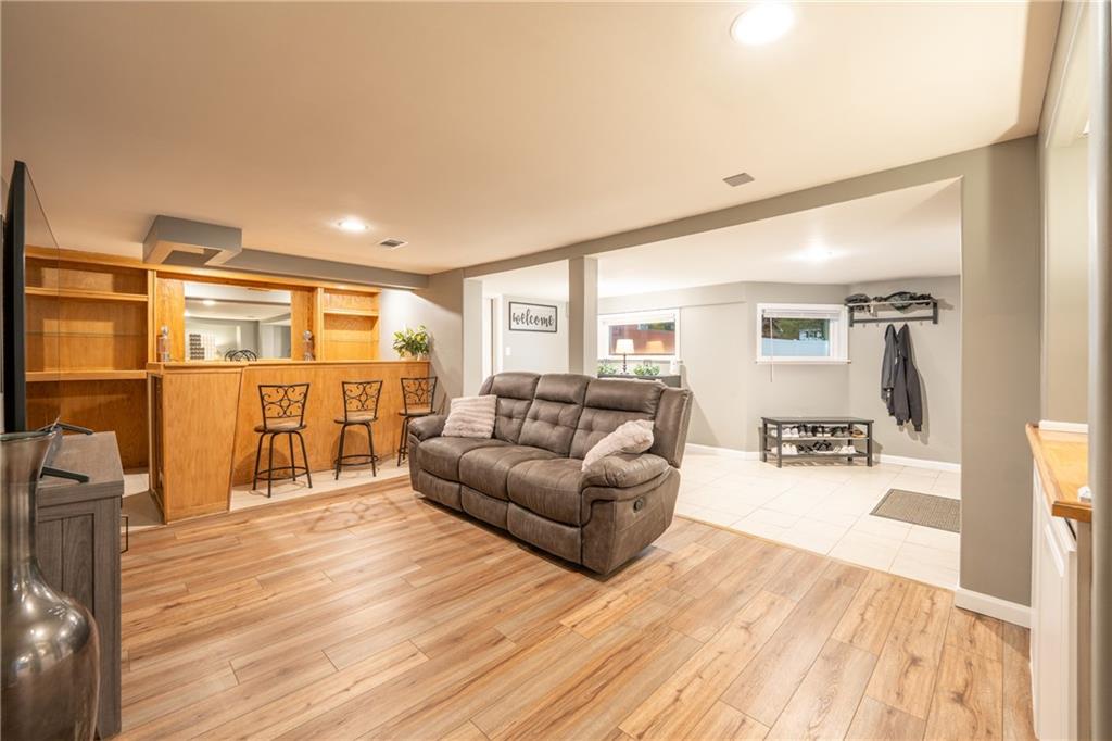136 Long Drive Irwin, PA 15642 - Photo 21 of 50 a living room with furniture a wooden floor and a large window