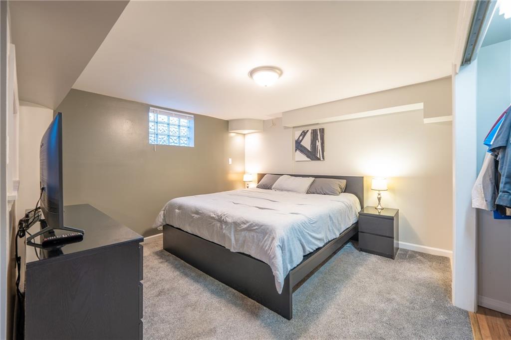 136 Long Drive Irwin, PA 15642 - Photo 24 of 50 a bedroom with a bed and a flat screen tv