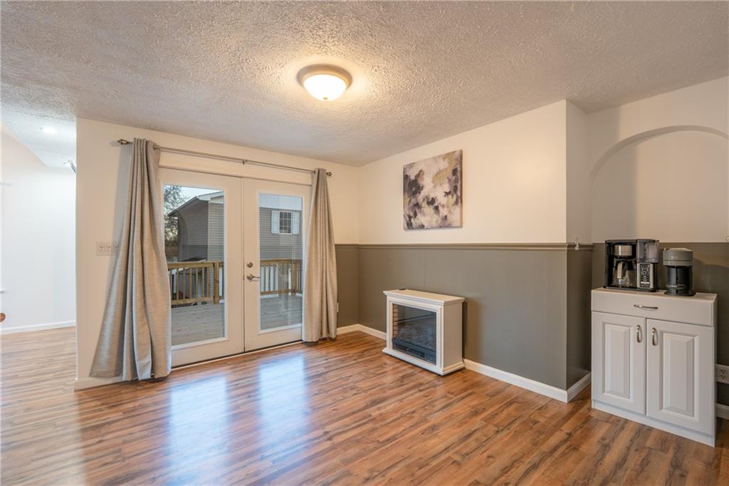 136 Long Drive Irwin, PA 15642 - Photo 9 of 50 an empty room with wooden floor and a fireplace