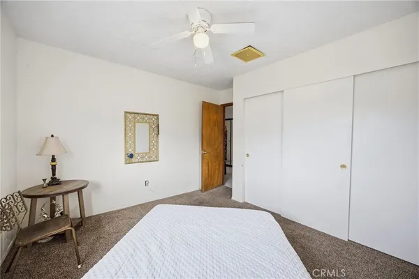 a bedroom with a bed and a table