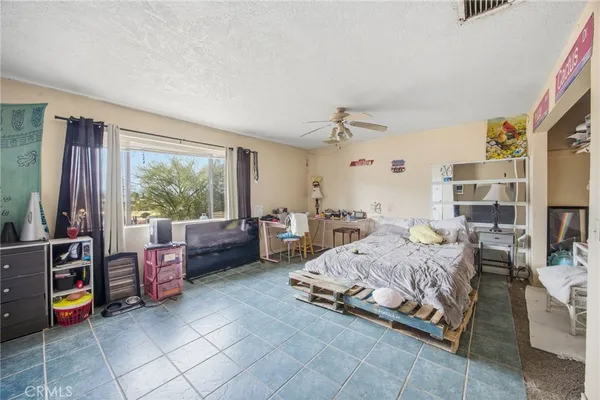 a bedroom with furniture and large windows