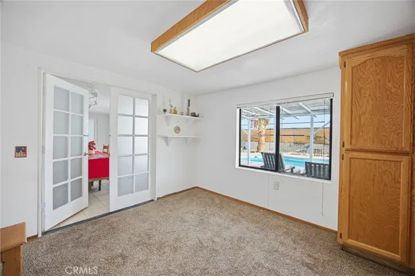 a view of a livingroom with an empty space and a window