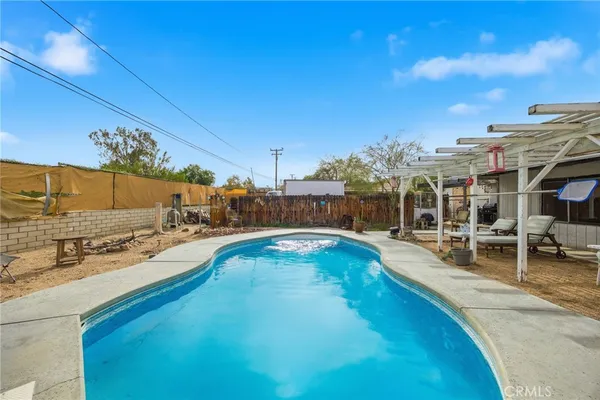 a view of a swimming pool with outdoor seating