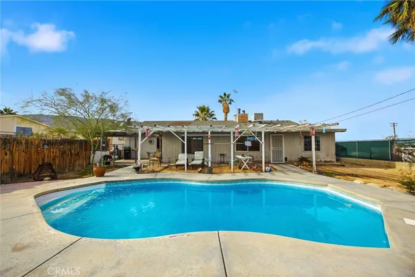 a view of a swimming pool with an outdoor seating
