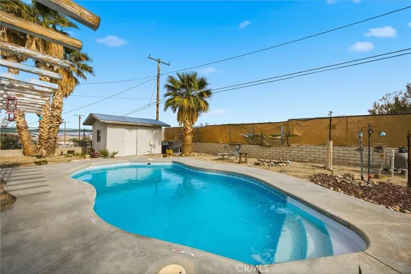 a view of a swimming pool with a lounge chair