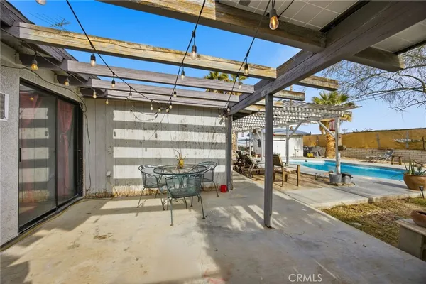 a view of a swimming pool with a patio