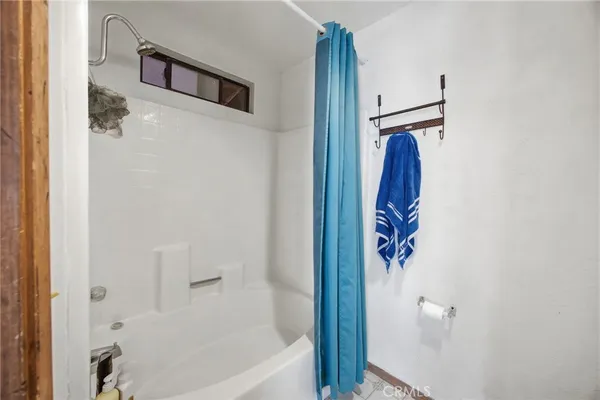 a bathroom with a bathtub and shower
