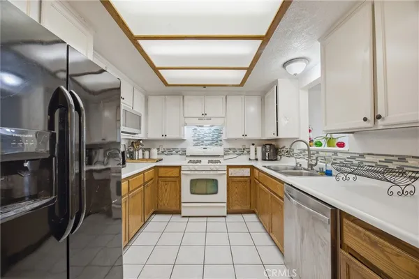 a kitchen with a sink cabinets stainless steel appliances and cabinets