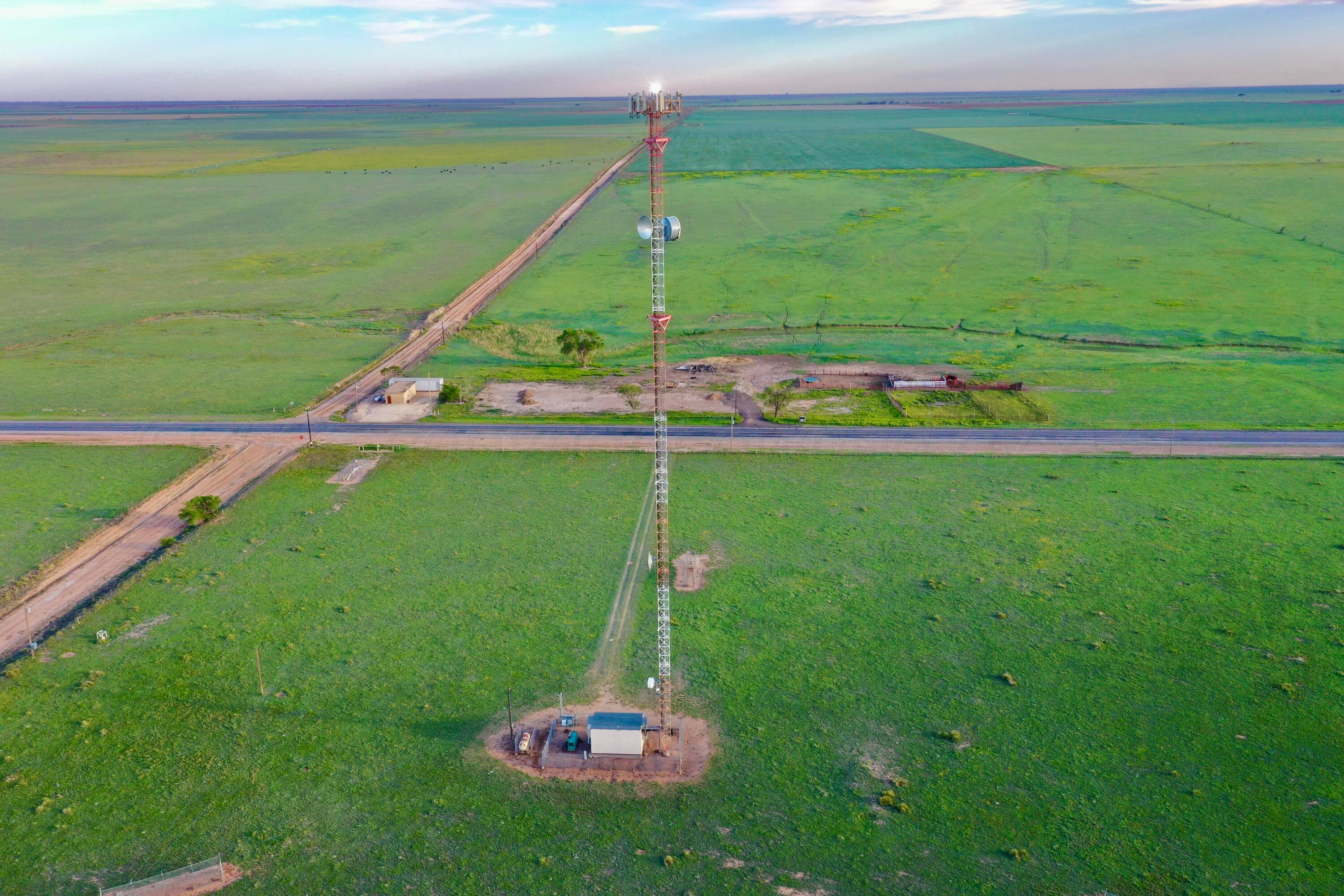 6675 Highway 86 Tulia, TX 79088 - Photo 26 of 68 a green field with lots of trees in the background
